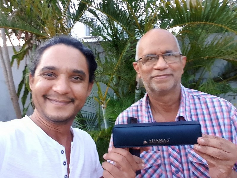 Kurt Francois from Explora remitting first prize to Desire Lilyman winner of second explora photo contest in Albion