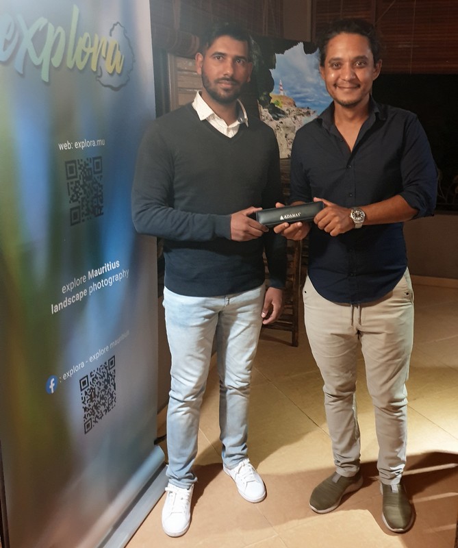 Kurt Francois from Explora remitting first prize in Albion to Twahir Nuckcheddy winner of fourth explora photo contest
