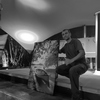 Saleem A Sam posing proudly next to his photo print at Flic en Flac
