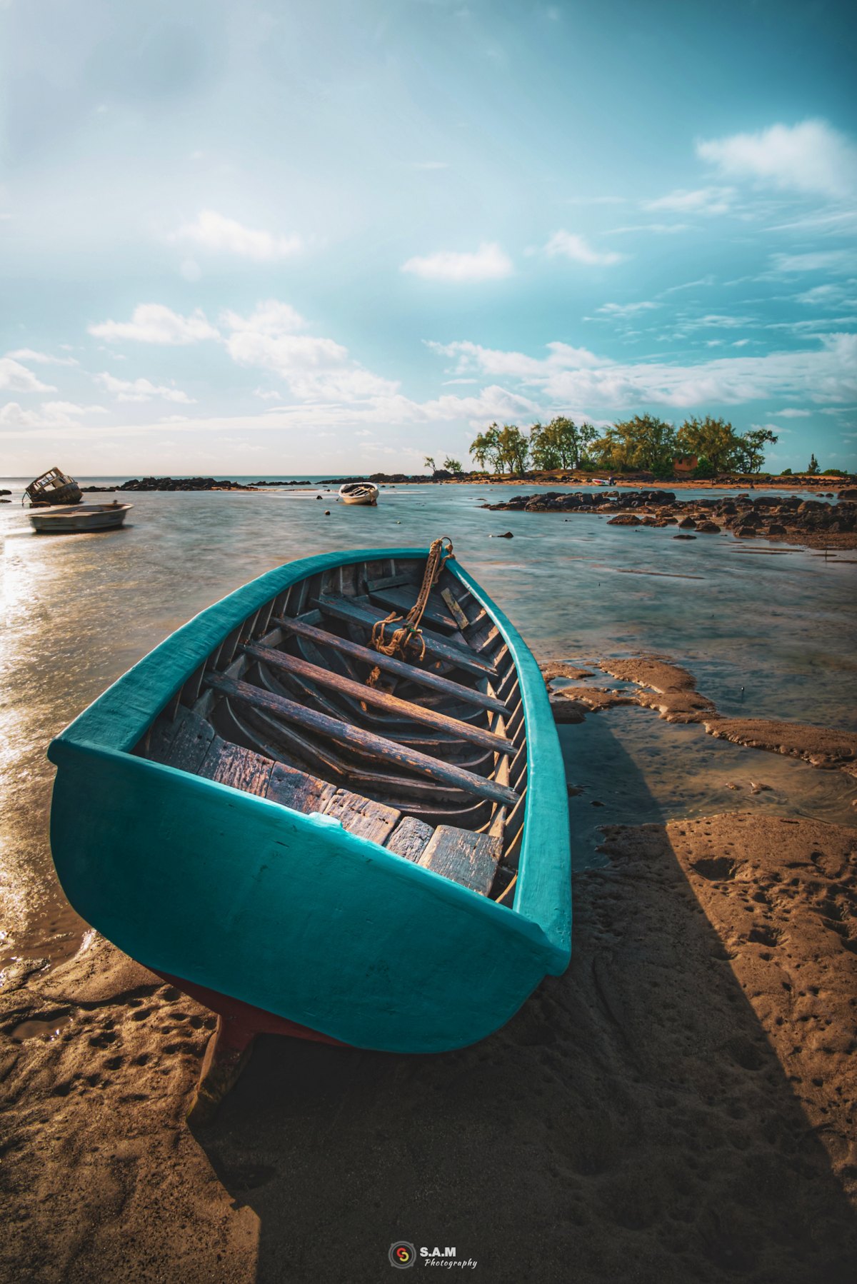 100+ Free Photos - Cyan colored fishing boat on beach of Grand Gaube